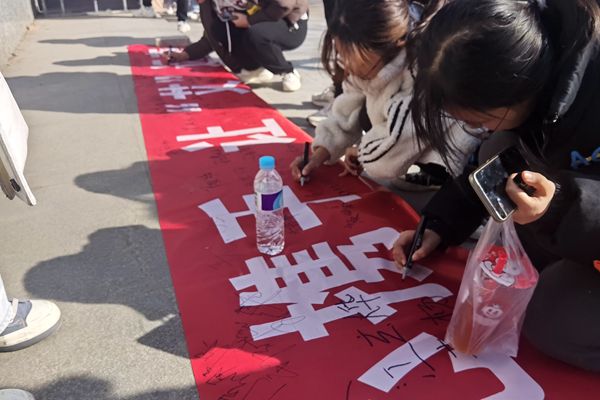 b371b789879148189e0fd7c46d299712.jpg 阳光团员们在宣传横幅上签名.jpg